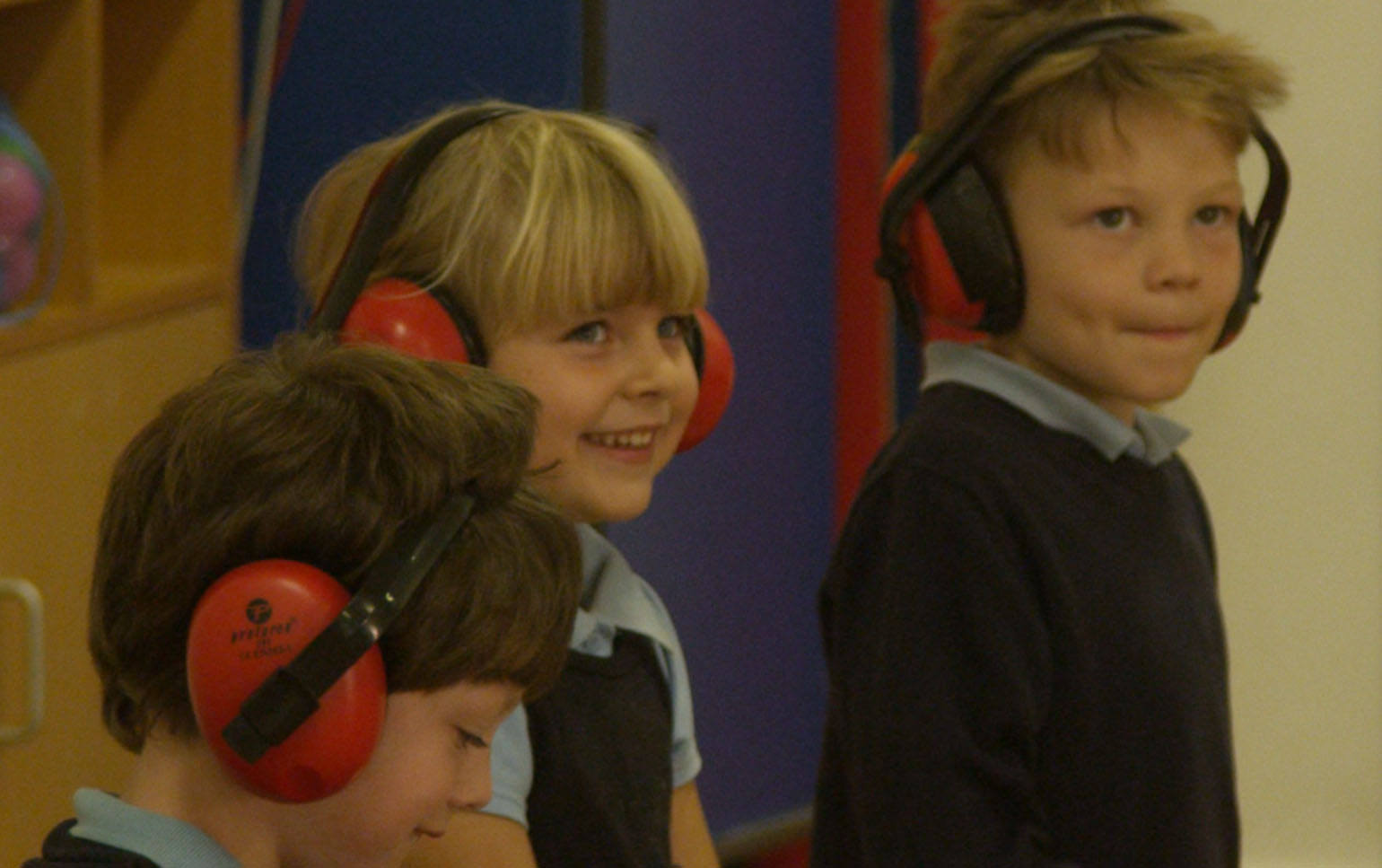 School children with ear muffs on